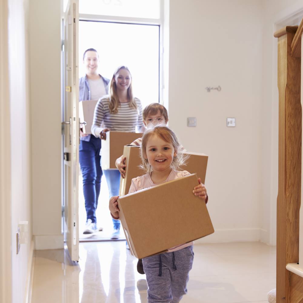 Family entering new house on moving day